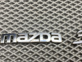 эмблема Mazda 3 1 поколение [рестайлинг] BK 2008, 1.6 л., Z6, бензин, МКПП, 16w, седан, передний привод, BN8V-51-710A, BN8V-51-721A - фото №2