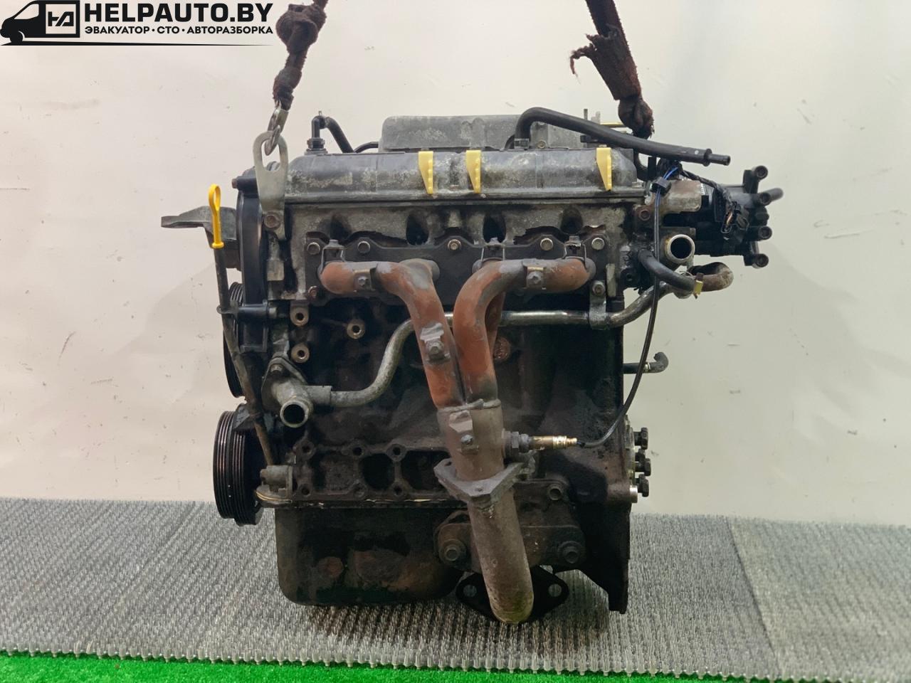 коллектор выпускной Mazda 323 6 поколение 1998, 1.4 л., бензин, МКПП, синий, хетчбэк 3 дв., передний привод - фото №1